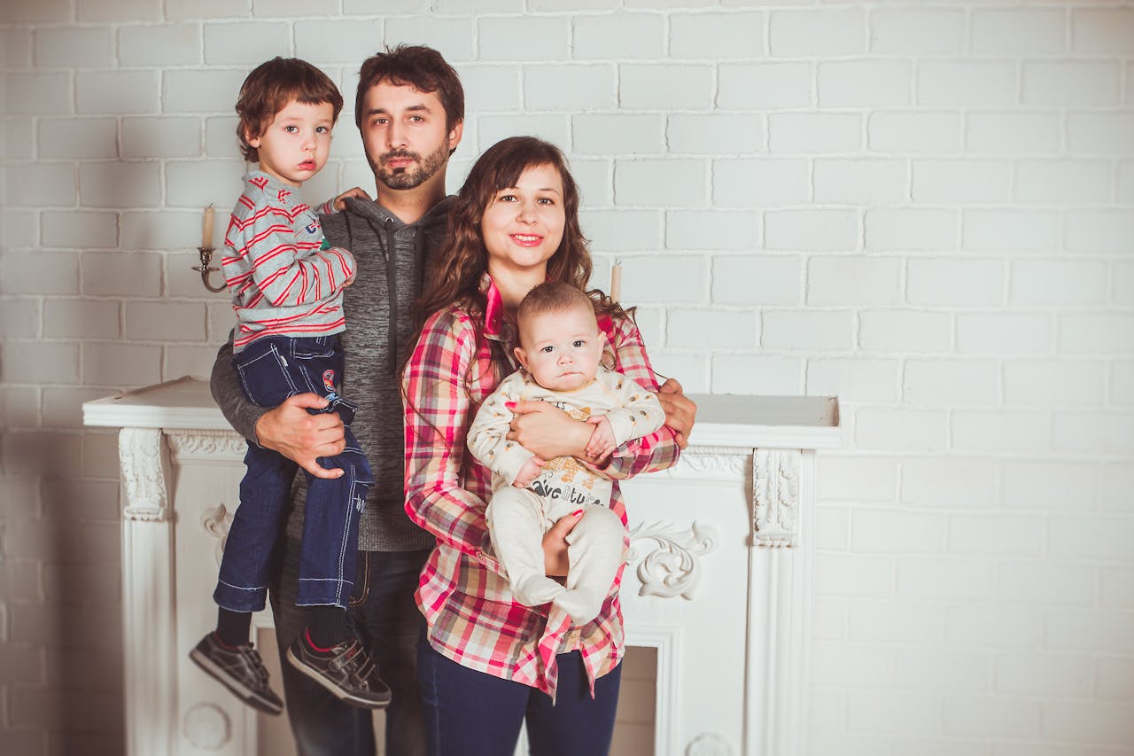 A joyful family posing together in a cozy living room, embodying love and togetherness.